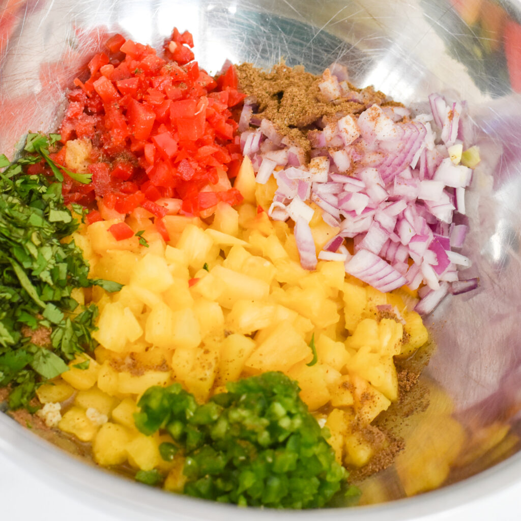 Fresh pineapple salsa ingredients in a mixing bowl